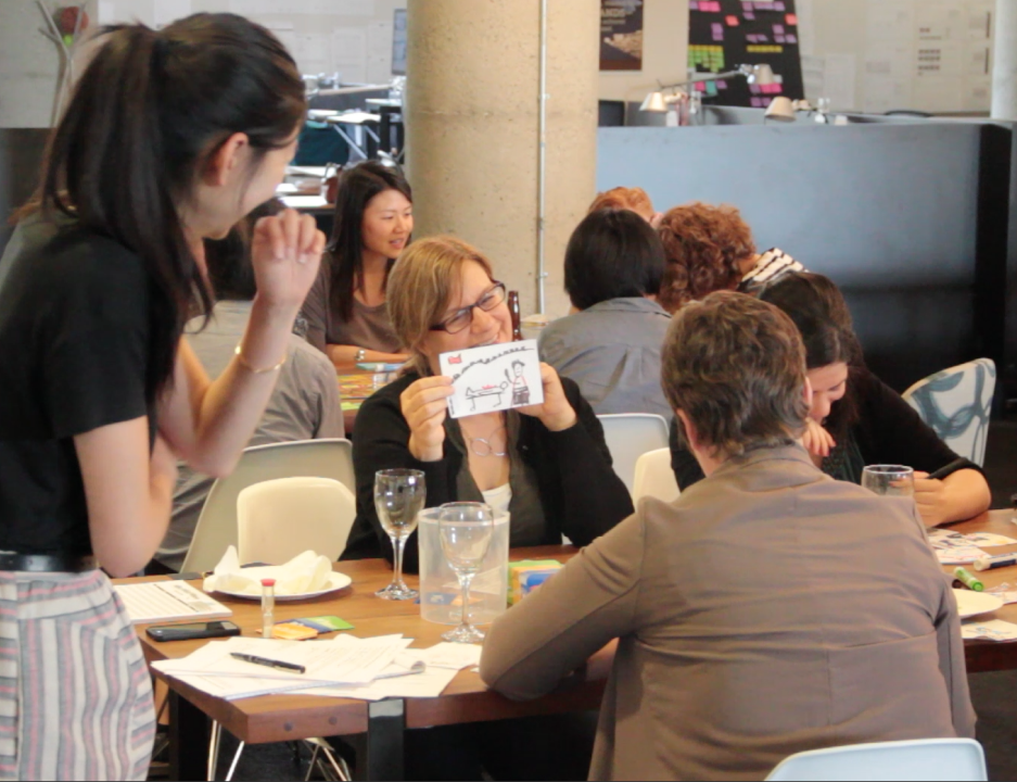 Agency staff playing drawing board games together at a game night